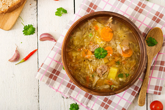 Traditional Russian soup with cabbage - sauerkraut soup. Flat lay. Top view