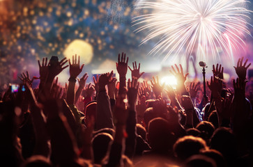 cheering crowd watching fireworks - new year concept