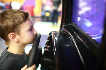 Boy playing in car simulator