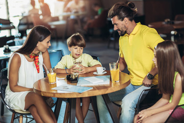 Four-member family having great time in a restaurant