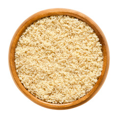 Ground walnuts in wooden bowl. Walnut meal, used in bakery. Grounded kernels, the seeds of the common walnut tree, Juglans regia. Isolated macro food photo close up from above on white background.
