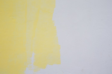 yellow paint roller on white wall