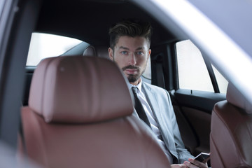 Handsome business man in car.