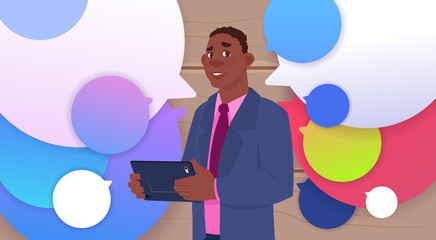 African American Businessman Holding Tablet Speak Over Colorful Chat Bubbles Flat Vector Illustration