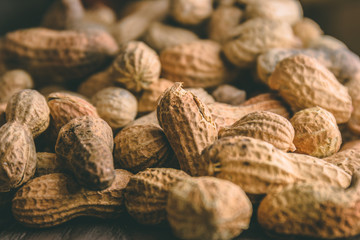 Close up of roasted peanuts on top of a table