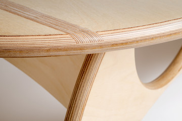 Close Up of Edge of Round Table Displaying Intricate Woodworking