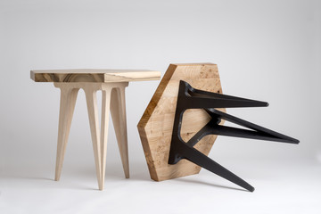 Two Modern Wooden Coffee Tables, One Tilted with Black Legs
