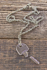 Fototapeta na wymiar Broken house key on chain on wooden background