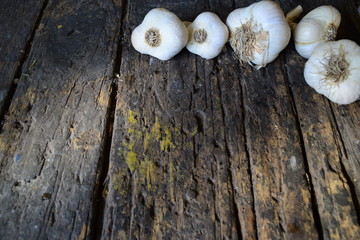heads of garlic on a dark wooden table
