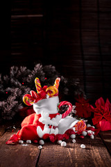 Christmas socks full of candy and sweets on wooden background.