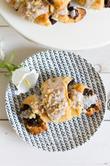 Poppy seeds croisssants. Traditional, polish croissants. White background, white wooden table and white plates.