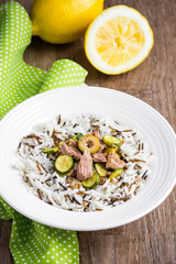 Mix of wild and white rice with canned tuna, zucchini, green olives and lemon, fresh, tasty diet dish, healthy food