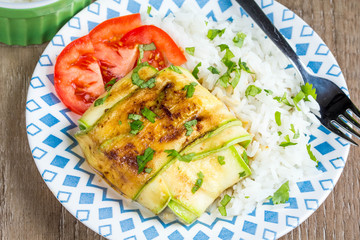 Fish grilled slices of zucchini, with tomatoes, cheese, stuffed vegetables, tasty diet food, healthy food