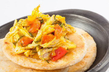 Traditional Colombian arepa topped with chicken breast