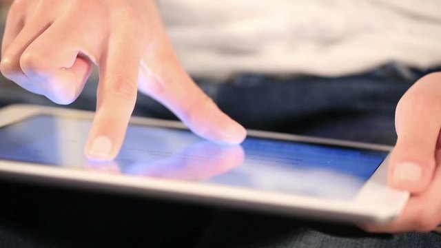 Hand touching digital tablet computer surface touchscreen.