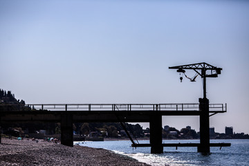 a flying seagull on the background of a crane