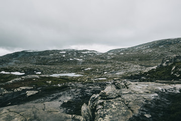 Heavy clouds hang over the mountains covered with snow