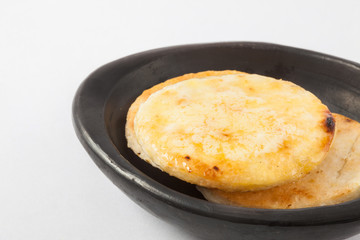 Traditional Colombian arepa topped with melted butter