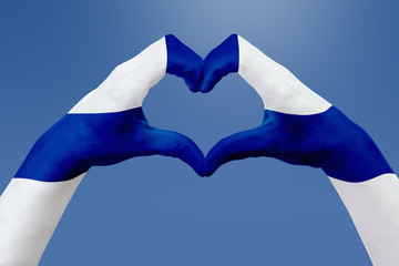 Hands flag of Finland, shape a heart. Concept of country symbol, on blue sky.