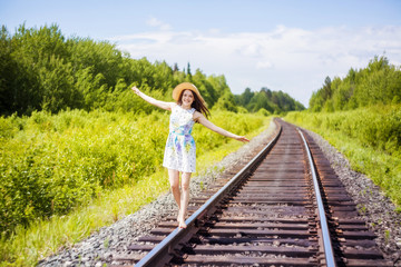 beautiful young brunette woman on the meadow