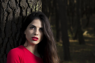 Fototapeta premium Portrait of beautiful young woman in the woods