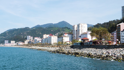 Fototapeta na wymiar Turkey.Hope in the Artvin silt. Provincial city on the Black Sea coast. High snow capped mountains on a background of a summer landscape with colorful houses of the city of Hopa