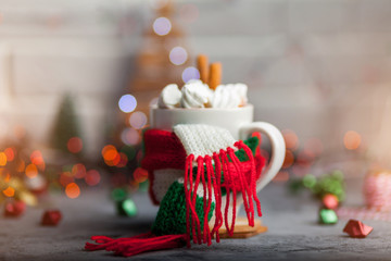 Hot winter beverage in a mug with warm scarf