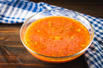 Traditional Ukrainian Russian vegetable borscht on the old wooden background.