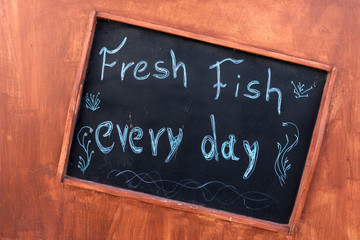 Handwritten sign at the restaurant - Fresh fish every day