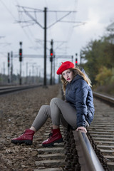 Young girl with red hat on railroad 