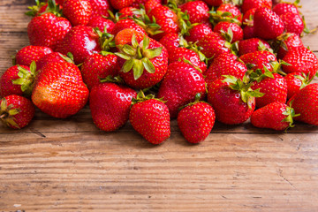 Fresh red strawberry on wood background