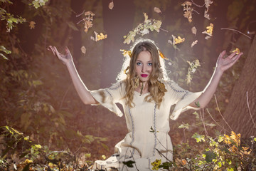 Fototapeta na wymiar Fantasy Fairy Tale Forest , young woman posing as nymph