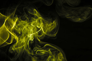 Yellow smoke on black background