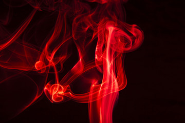 Red smoke on black background