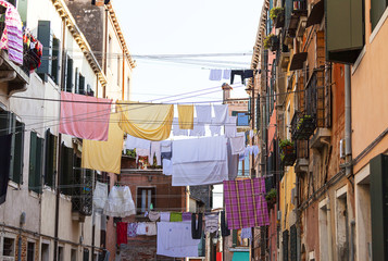 Typical view; the streets of Venice; washed clothes drying on cords outside the building, Venice, Italy.