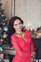 brunette girl in the national Indian costume from a Christmas tree