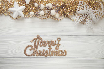 christmas background with holiday ornaments on white wood background with text: merry christmas