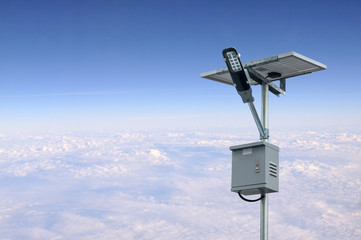 Solar panel lighting pole with blue sky and white clouds. Renewable Energy concept.