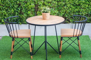 Modern coffee and tea table set with chairs and flower rattan basket, no smoking table sign lay on table in smoking area