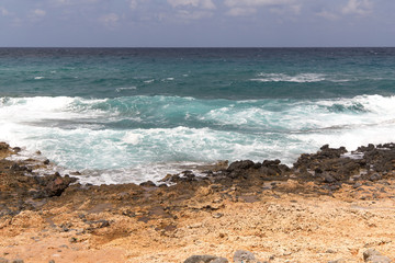 Seashore cloudy beach landscape with open water and waves