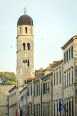 Fototapeta na wymiar The bell tower of the Franciscan church and monastery in the main city street Stradun in Dubrovnik, Croatia.