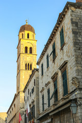 The bell tower of the Franciscan church and monastery in the main city street Stradun in Dubrovnik, Croatia.