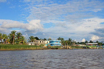 Traditional fishing boats and houses, Cayapas River, Esmeraldas province, Ecuador, South America