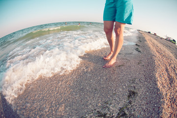 girl is walking along the beach.