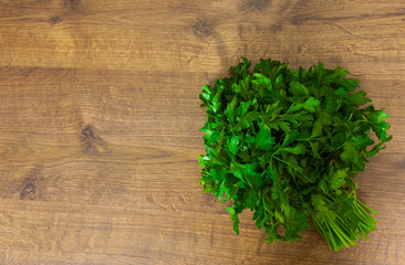 Fototapeta na wymiar Fresh parsley on a wooden background. with copy space. top view