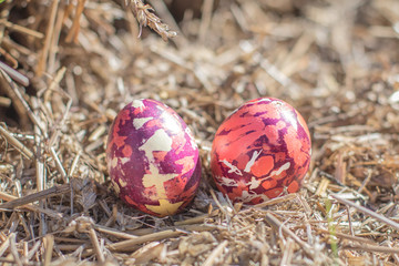 Happy easter modern handmade colorful eggs straw background