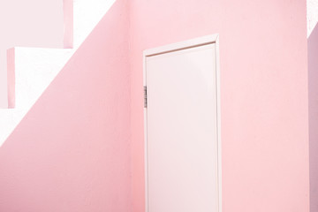 white door on pink wall