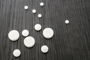 Some Round White Pills Of Different Size 