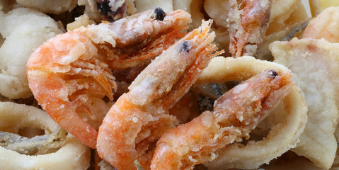 three big shrimp and other fried fish and seafood in the fish re
