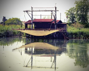 stilts houses with fishing nets for fishing on the river with vi